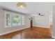 Open living space featuring ample natural light, hardwood floors and modern ceiling fan at 2609 Elmhurst Cir, Raleigh, NC 27610