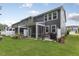 A spacious backyard with lush lawn, screened porch, and outdoor grill at 273 Millennium Dr, Pittsboro, NC 27312