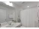 Well-lit bathroom with a modern vanity, framed mirror, and shower with curtain at 273 Millennium Dr, Pittsboro, NC 27312