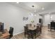 Dining area features an eye-catching light fixture, a large table, and provides views to kitchen and living areas at 273 Millennium Dr, Pittsboro, NC 27312