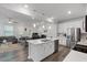 Open-concept kitchen with white cabinets, stainless steel appliances, and island with pendant lighting at 273 Millennium Dr, Pittsboro, NC 27312