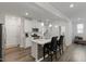 Bright, open kitchen featuring an island, white cabinets, and stainless steel appliances at 273 Millennium Dr, Pittsboro, NC 27312