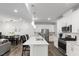 Modern kitchen with white cabinets, stainless steel appliances, and an island with bar seating at 273 Millennium Dr, Pittsboro, NC 27312