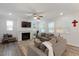 Comfortable living room with a fireplace, large TV, and open layout with natural light at 273 Millennium Dr, Pittsboro, NC 27312
