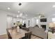 Open layout living room featuring a stone fireplace, large TV, and dining area at 273 Millennium Dr, Pittsboro, NC 27312