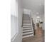 Staircase with wooden treads and white risers, leading to the upper level at 273 Millennium Dr, Pittsboro, NC 27312