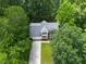 Aerial shot of two-story home with grey roof, attached garage, and long driveway at 2750 Michelle Ct, Creedmoor, NC 27522