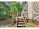 View of the backyard wood deck with stairs leading down into yard at 2750 Michelle Ct, Creedmoor, NC 27522