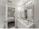 Bright bathroom featuring double sinks and vanity with the bedroom as a backdrop at 2750 Michelle Ct, Creedmoor, NC 27522