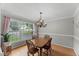 Charming dining room with ample natural light, chandelier and wood table at 2750 Michelle Ct, Creedmoor, NC 27522