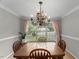 Inviting dining area featuring a chandelier, large window, and a view of the front yard at 2750 Michelle Ct, Creedmoor, NC 27522