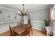 Elegant dining room with chandelier and hardwood floors, perfect for Gathering meals and entertaining guests at 2750 Michelle Ct, Creedmoor, NC 27522
