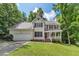 Charming two-story home featuring a well-manicured lawn, attached garage, and inviting front porch at 2750 Michelle Ct, Creedmoor, NC 27522