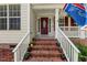 Inviting front porch with brick steps and colorful flower pots creating a welcoming entrance at 2750 Michelle Ct, Creedmoor, NC 27522