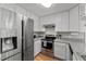 Modern kitchen boasts stainless steel appliances, white cabinets and hardwood floors at 2750 Michelle Ct, Creedmoor, NC 27522