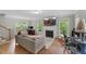 Bright living room with hardwood floors, a fireplace, and large windows overlooking the backyard at 2750 Michelle Ct, Creedmoor, NC 27522