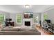 Cozy living room with a fireplace, hardwood floors, and natural light enhancing the inviting atmosphere at 2750 Michelle Ct, Creedmoor, NC 27522