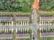 Aerial view of a townhome community at an intersection surrounded by tree lined streets at 287 White Oak Ridge Dr, Garner, NC 27529