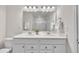Bright bathroom with double sink vanity, quartz counters and shower with seamless glass door at 287 White Oak Ridge Dr, Garner, NC 27529