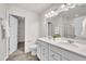 Bright bathroom with double sink vanity, quartz counters and an open doorway to the walk-in closet at 287 White Oak Ridge Dr, Garner, NC 27529