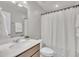 Well-lit bathroom featuring a modern vanity with white countertop and a shower/tub with curtain at 287 White Oak Ridge Dr, Garner, NC 27529