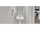 Clean half bathroom with pedestal sink is conveniently located next to a kitchen with stainless appliances at 287 White Oak Ridge Dr, Garner, NC 27529