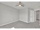 Neutral bedroom with a modern ceiling fan and view of the hall at 287 White Oak Ridge Dr, Garner, NC 27529