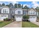 Charming townhomes with attached garages, manicured lawns, and professionally landscaped front yards at 287 White Oak Ridge Dr, Garner, NC 27529