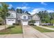 Charming townhomes with manicured lawns and driveways under a sunny sky at 287 White Oak Ridge Dr, Garner, NC 27529