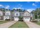 Attractive townhomes with attached garages, charming landscaping, and tree lined street at 287 White Oak Ridge Dr, Garner, NC 27529