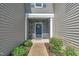 Inviting front entryway featuring a blue door with wreath and stone accent wall at 287 White Oak Ridge Dr, Garner, NC 27529