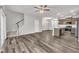Open-concept living area with stairs, hardwood flooring, and adjacent kitchen for seamless entertaining and modern living at 287 White Oak Ridge Dr, Garner, NC 27529