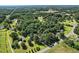 Aerial view of the property at 3005 Piney Grove Wilbon Rd surrounded by mature trees at 3005 Piney Grove Wilbon Rd, Holly Springs, NC 27540