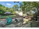 Backyard patio with rocking chairs, firepit, partially fenced yard, and house exterior at 3005 Piney Grove Wilbon Rd, Holly Springs, NC 27540