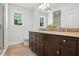 Bathroom features a double vanity with granite countertop, tiled flooring and two windows at 3005 Piney Grove Wilbon Rd, Holly Springs, NC 27540