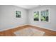 Bedroom features hardwood flooring, two windows and neutral paint at 3005 Piney Grove Wilbon Rd, Holly Springs, NC 27540