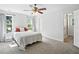 Spacious bedroom with two windows, neutral colors, carpet flooring, and a ceiling fan at 3005 Piney Grove Wilbon Rd, Holly Springs, NC 27540