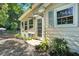 Exterior view of home with a stone driveway, lush landscaping and a covered entrance at 3005 Piney Grove Wilbon Rd, Holly Springs, NC 27540