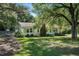 A beautiful home shaded by mature trees and features a well-kept lawn and landscaping at 3005 Piney Grove Wilbon Rd, Holly Springs, NC 27540