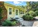 Inviting front entrance with a brick chimney, light shutters, and manicured landscaping, and well maintained lawn at 3005 Piney Grove Wilbon Rd, Holly Springs, NC 27540