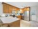 Charming kitchen with wood cabinets, stainless appliances, and a breakfast bar at 3005 Piney Grove Wilbon Rd, Holly Springs, NC 27540