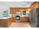 Bright kitchen with wooden cabinets, stainless steel appliances, and tiled flooring at 3005 Piney Grove Wilbon Rd, Holly Springs, NC 27540