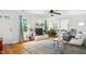 A relaxing and airy living room featuring a beautiful fireplace, wood floors, and lots of natural light at 3005 Piney Grove Wilbon Rd, Holly Springs, NC 27540