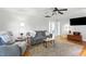 A brightly-lit living room showcasing modern furniture, sleek hardwood floors, and lots of natural light at 3005 Piney Grove Wilbon Rd, Holly Springs, NC 27540