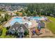 Aerial view of community amenities including pools, playground, and clubhouse surrounded by homes at 3058 Hyco Lake Ct, Fuquay Varina, NC 27526