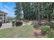 Landscaped backyard with mature trees, grassy areas, and patio space for relaxing at 3058 Hyco Lake Ct, Fuquay Varina, NC 27526