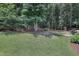 Lush, green backyard featuring mature trees for privacy at 3058 Hyco Lake Ct, Fuquay Varina, NC 27526