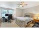 Neutral bedroom with bed, desk and chair, with a ceiling fan and natural light from a double window at 3058 Hyco Lake Ct, Fuquay Varina, NC 27526