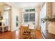 Sunlit dining area has hardwood floors, large windows, and a white table at 3058 Hyco Lake Ct, Fuquay Varina, NC 27526