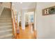 Hallway with hardwood floors leading to a cozy living area and dining nook at 3058 Hyco Lake Ct, Fuquay Varina, NC 27526